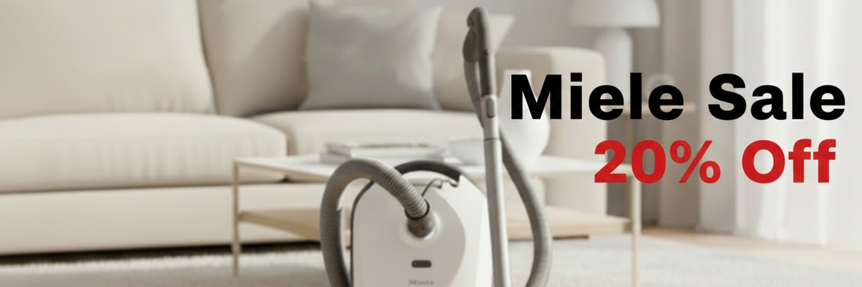 A white and gray canister vacuum cleaner stands on a light wood floor in a bright living room, with a gray cat sitting beside it. Large sale text reads 'Miele Sale 20% Off' over the right side.